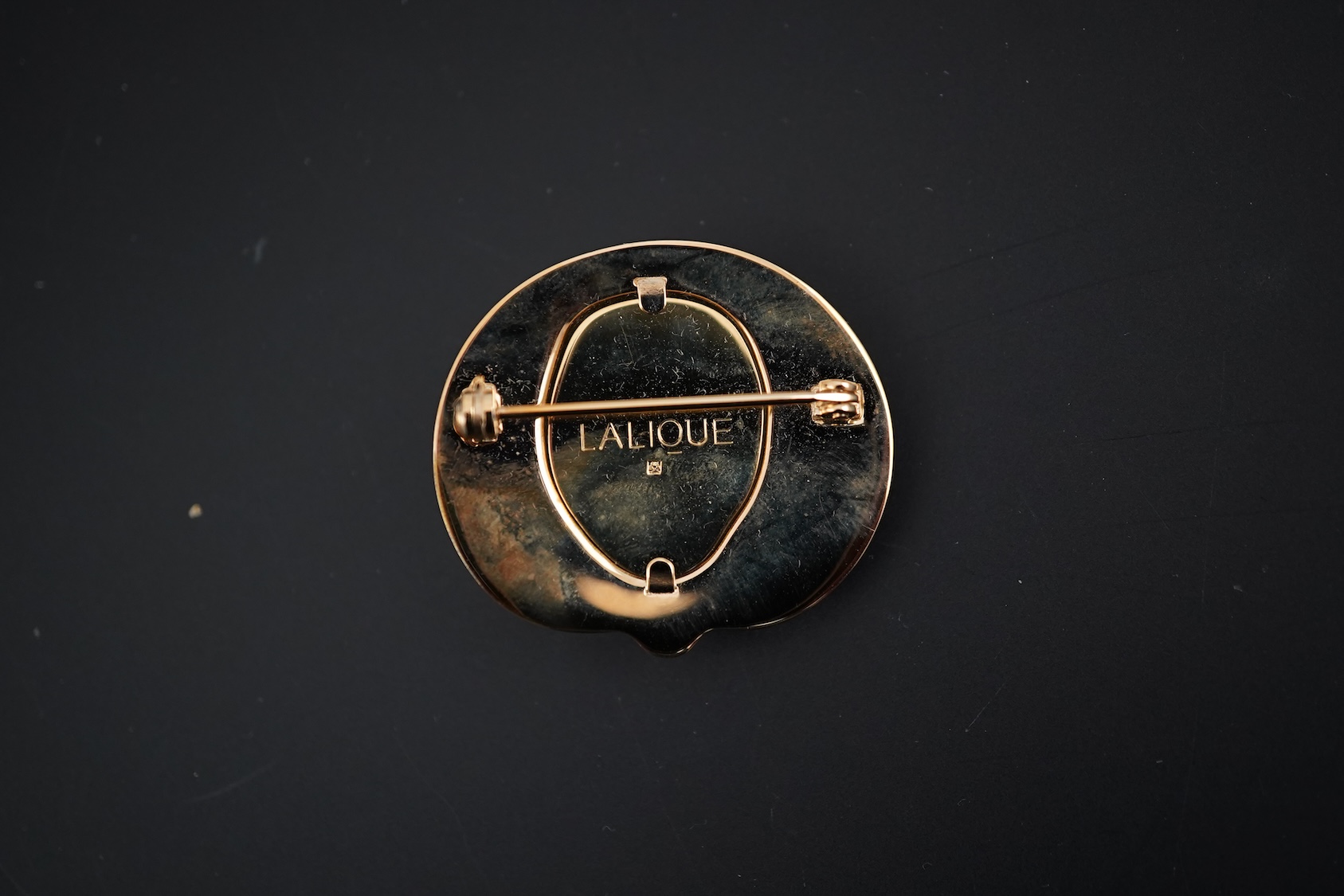 A Lalique mask brooch, cased